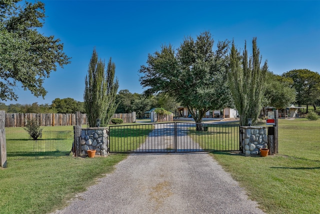 view of gate featuring a yard