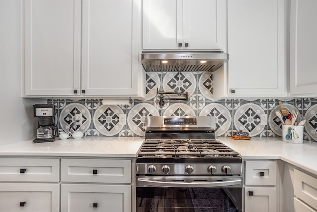 kitchen with stainless steel range with gas cooktop, white cabinetry, and ventilation hood