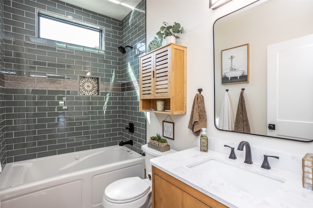 full bathroom featuring tiled shower / bath, vanity, and toilet