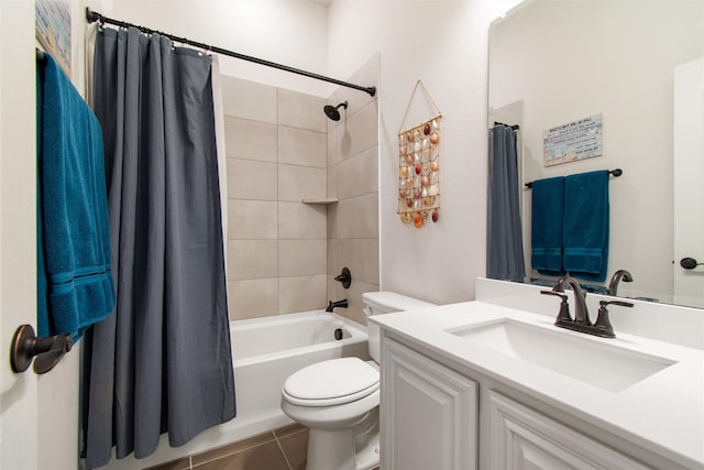 full bathroom featuring shower / bath combination with curtain, tile patterned floors, vanity, and toilet