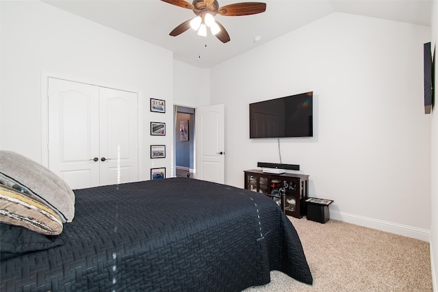 bedroom featuring lofted ceiling, a closet, carpet flooring, and ceiling fan