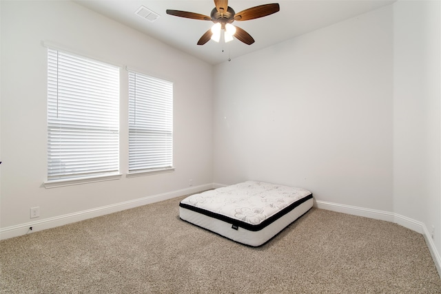 unfurnished bedroom with ceiling fan and carpet