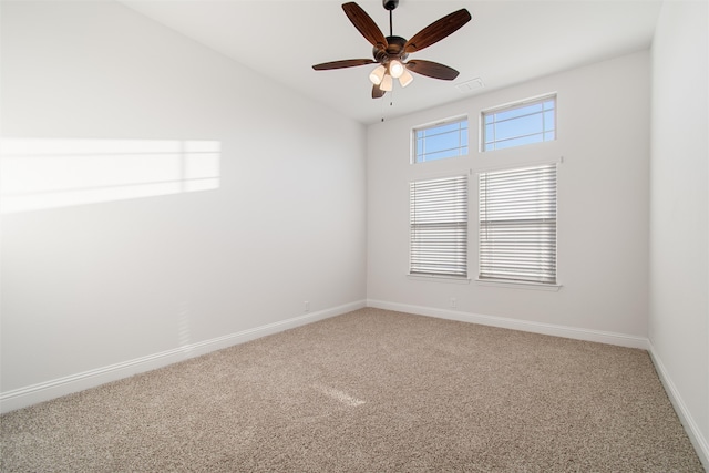 unfurnished room with ceiling fan and carpet flooring