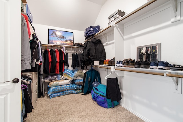 walk in closet featuring lofted ceiling and carpet flooring