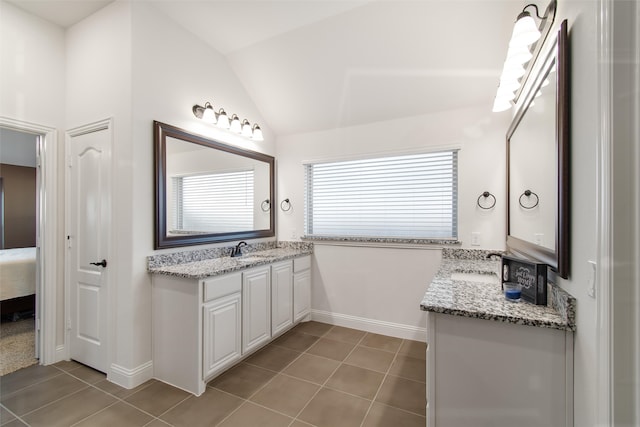 bathroom featuring lofted ceiling, tile patterned floors, and vanity