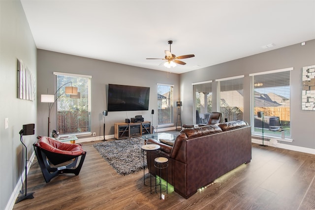 living room featuring ceiling fan and dark hardwood / wood-style floors