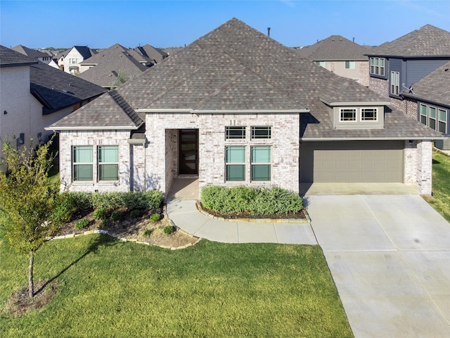 view of front of house with a front yard and a garage