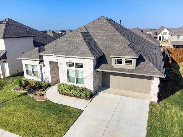 view of front facade with a front yard and a garage