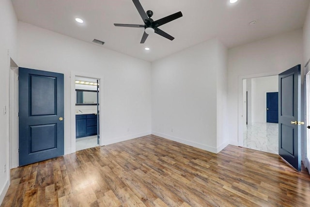 spare room with hardwood / wood-style flooring and ceiling fan