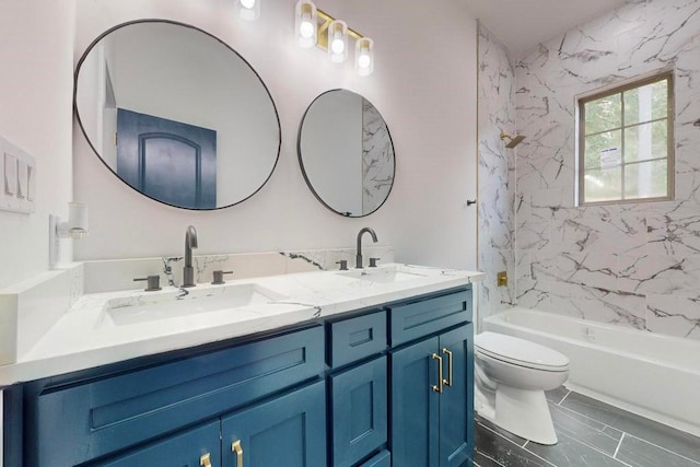 full bathroom featuring tiled shower / bath, toilet, and vanity