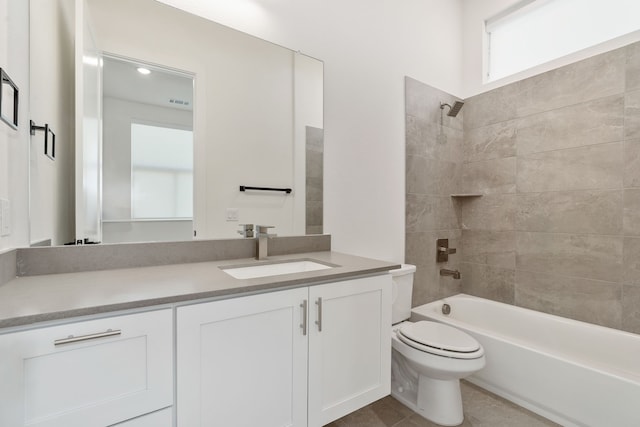 full bathroom featuring tile patterned floors, vanity, toilet, and tiled shower / bath