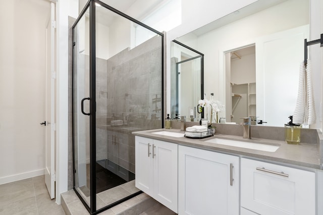 bathroom with tile patterned floors, vanity, and an enclosed shower