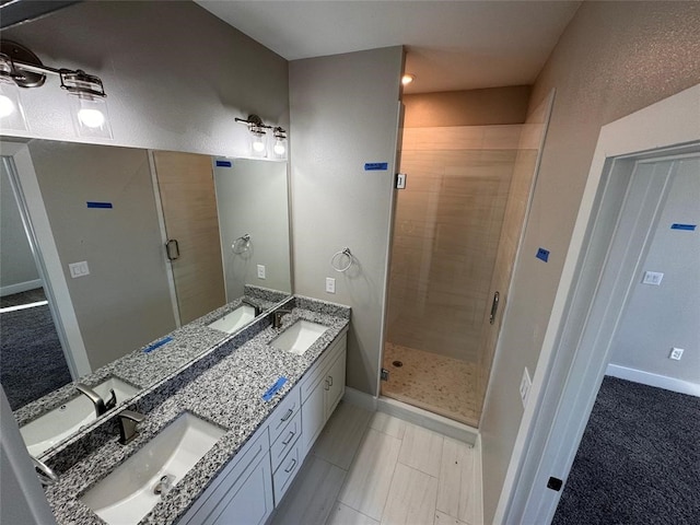 bathroom with tile patterned floors, walk in shower, and vanity