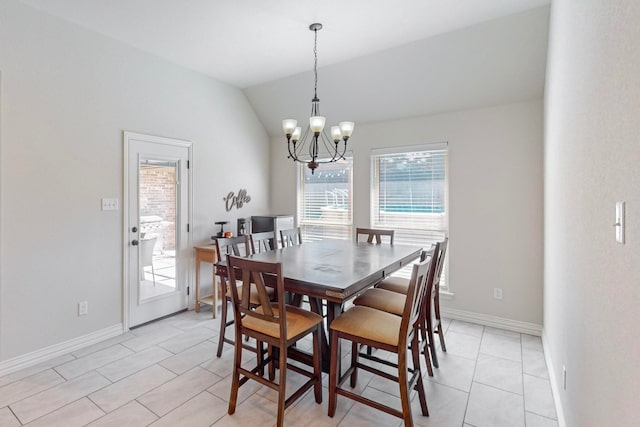 dining room featuring light tile patterned flooring, vaulted ceiling, and an inviting chandelier