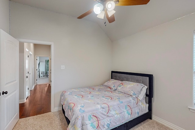 bedroom with vaulted ceiling, hardwood / wood-style floors, and ceiling fan