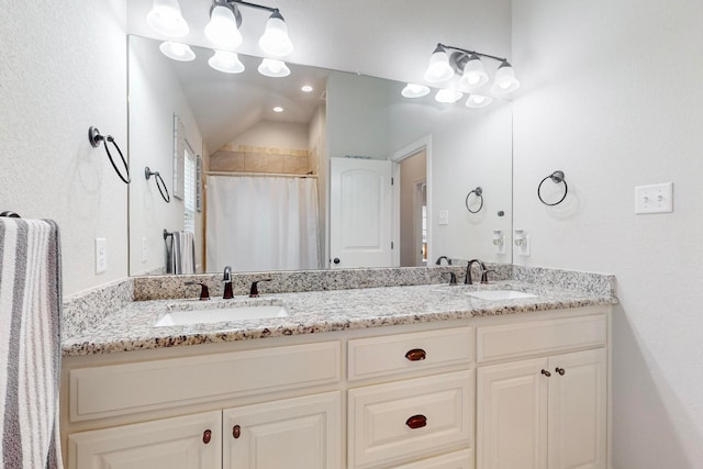 bathroom with vanity, lofted ceiling, and a shower with shower curtain