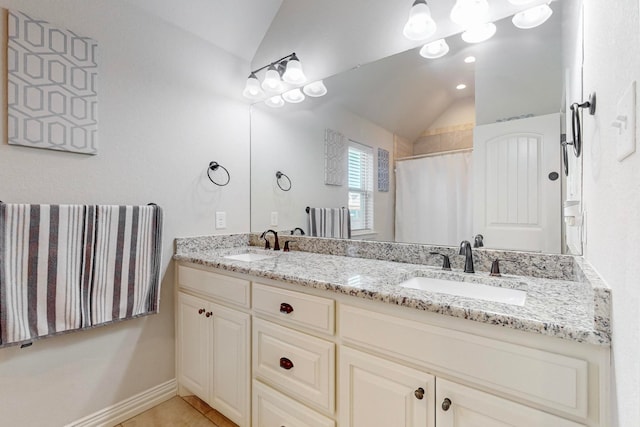 bathroom featuring vaulted ceiling, walk in shower, vanity, and tile patterned floors