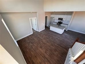 unfurnished living room with dark wood-type flooring