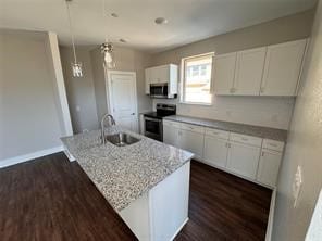 kitchen featuring a kitchen island with sink, stainless steel appliances, and white cabinetry