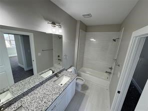 full bathroom with vanity, toilet, and tiled shower / bath