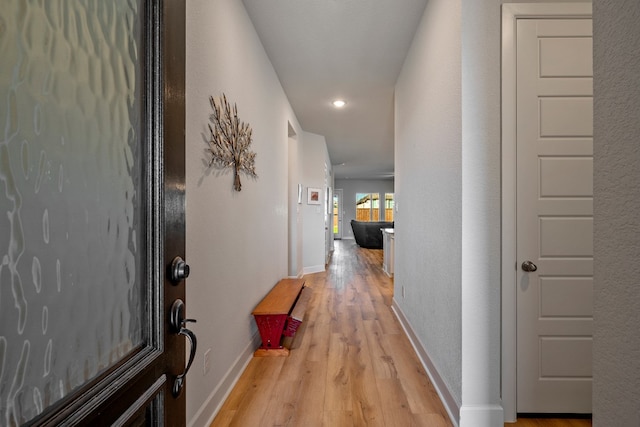 corridor with light wood-type flooring