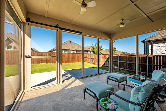 sunroom with ceiling fan