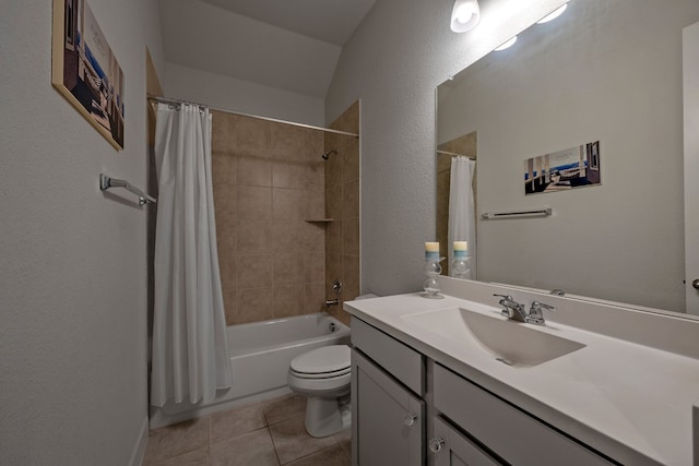 full bathroom with shower / bath combo with shower curtain, tile patterned floors, vanity, and toilet