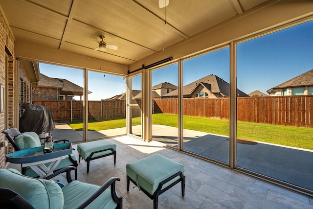 sunroom featuring ceiling fan