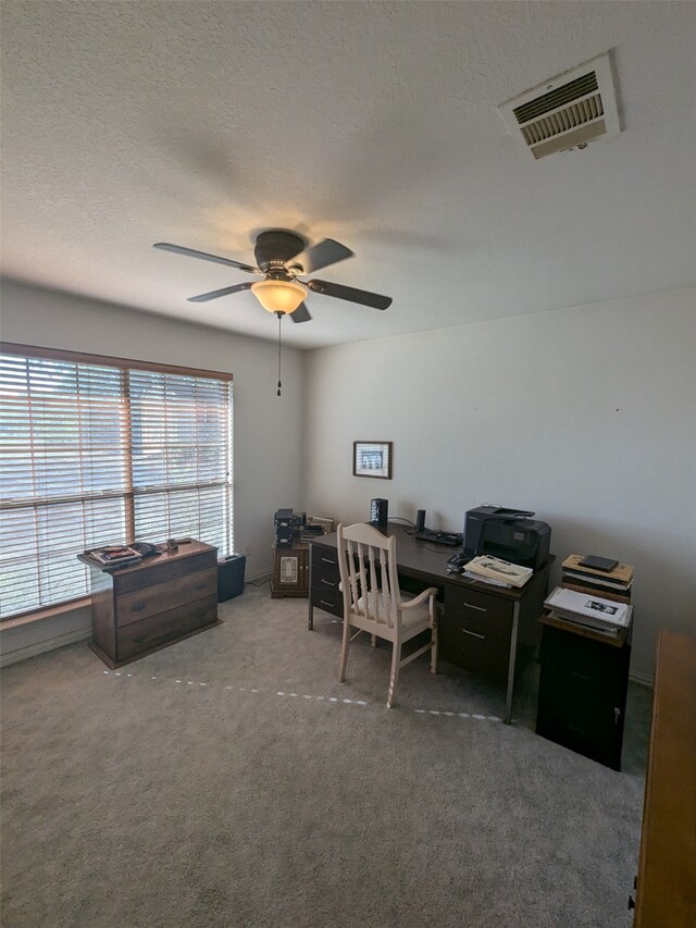 office space featuring a textured ceiling, carpet floors, and ceiling fan