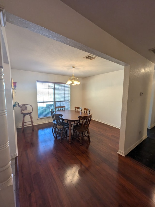 dining area featuring a chandelier and dark hardwood / wood-style flooring