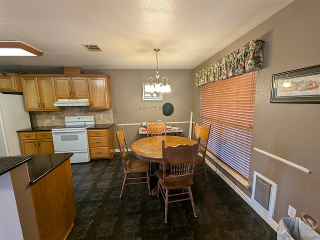 dining space with dark wood-type flooring, a notable chandelier, and a textured ceiling