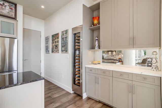 2600 W 7th St Unit 2746, Fort Worth, TX 76107 - kitchen featuring freestanding refrigerator, open shelves, light wood finished floors, stone countertops, and recessed lighting