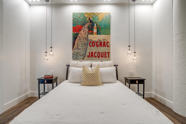 bedroom with dark wood-type flooring