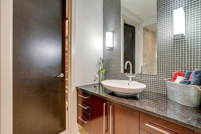 bathroom featuring vanity, tile walls, and tasteful backsplash