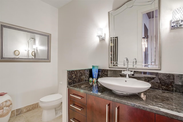 bathroom with vanity, toilet, and tile patterned floors