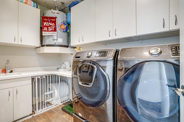 laundry room with separate washer and dryer, sink, electric water heater, and cabinets