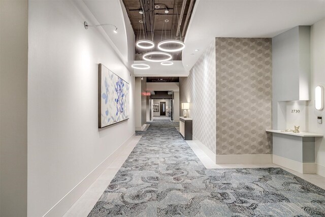 2600 W 7th St Unit 2746, Fort Worth, TX 76107 - hallway featuring an accent wall, baseboards, and wallpapered walls