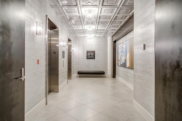 hall featuring elevator and light tile patterned flooring