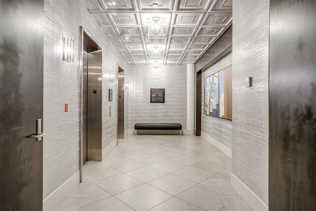 2600 W 7th St Unit 2746, Fort Worth, TX 76107 - hall featuring an ornate ceiling, baseboards, elevator, and light tile patterned floors