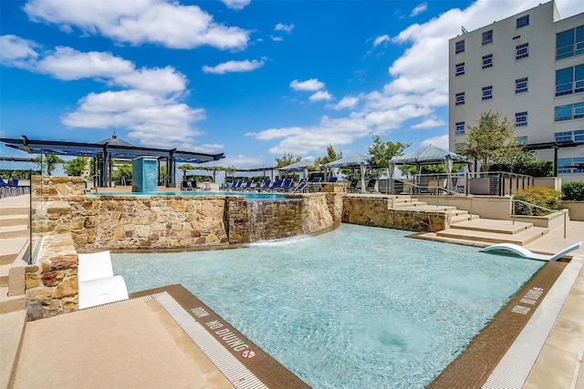 view of swimming pool featuring a gazebo, a hot tub, and pool water feature