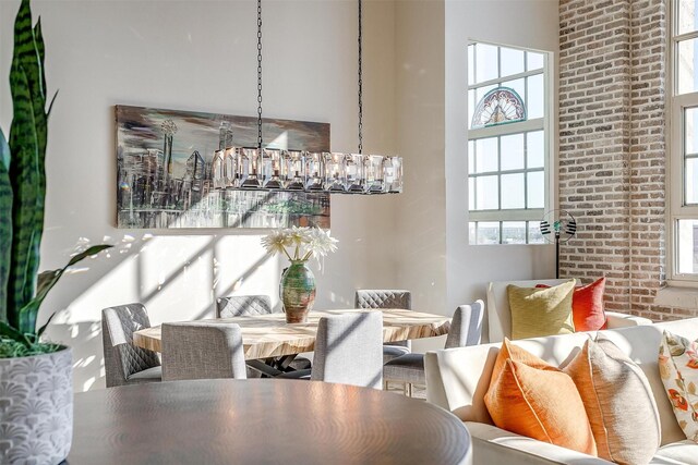 2600 W 7th St Unit 2746, Fort Worth, TX 76107 - dining area with a towering ceiling, a chandelier, and brick wall
