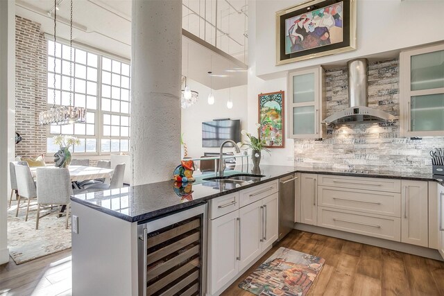 2600 W 7th St Unit 2746, Fort Worth, TX 76107 - kitchen with wine cooler, wall chimney range hood, a high ceiling, stainless steel dishwasher, and a sink