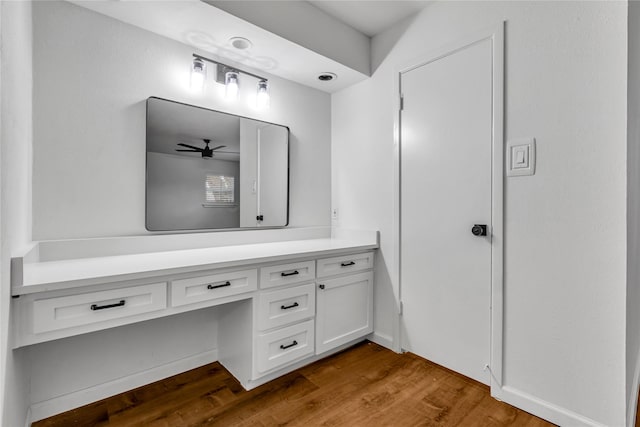 bathroom with wood finished floors, vanity, and a ceiling fan