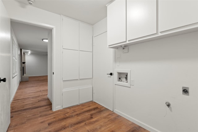 laundry area with hookup for a washing machine, cabinet space, hookup for an electric dryer, and wood finished floors