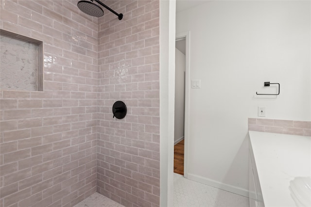 bathroom featuring tile patterned floors, vanity, and tiled shower