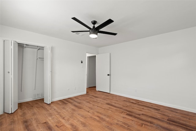 unfurnished bedroom with a ceiling fan, visible vents, light wood-style flooring, and baseboards