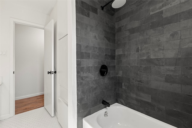 bathroom featuring tile patterned flooring and tiled shower / bath combo