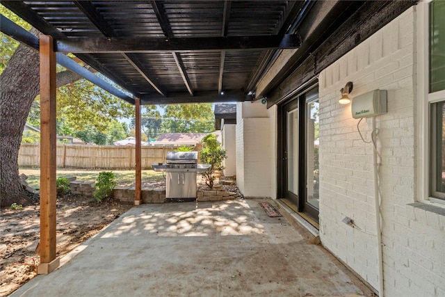 view of patio featuring fence, grilling area, and a pergola