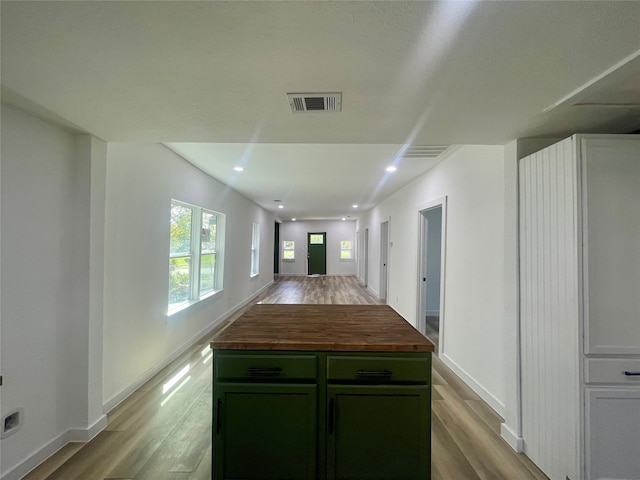 kitchen featuring light wood-type flooring, wood counters, and a kitchen island