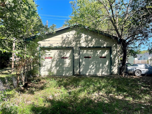 view of property exterior featuring an outbuilding and a garage